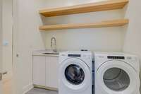 Walk-in laundry room w/sink, new washer/dryer, floating wood shelves