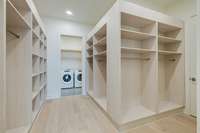 Dream walk-in closet w/custom shelving + laundry room access