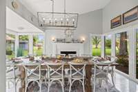 The view as you enter the dining room, which features a gas fireplace and walls of windows.