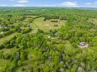 Drone view from the back of the property, which shows you the wooded back 5 or so acres.  Thank you for taking the time to view this listing and considering this as your potential              HOME SWEET HOME!