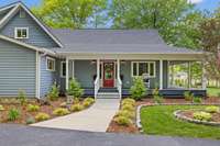 You are greeted by a red front door and beautiful landscaping.  There are two parking spaces directly across from this area.