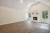 Large Living Room with Vaulted Ceilings, Beautiful Gas Fireplace and recessed Lighting.