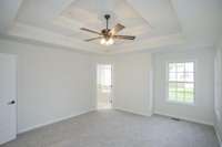 Primary Bedroom with double trey ceiling.