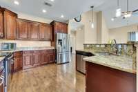 Kitchen has plenty of cabinets and granite countertop space for those holiday gatherings