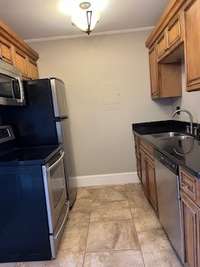 Stainless steel appliances. Dishwasher and garbage disposal replaced last year. Tiled kitchen floor.