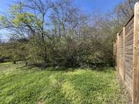 backyard has a beautiful privacy fence on 3 sides, open to the "urban forest" as the 4th wall.