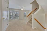 View into living room and bay window from kitchen. NEW windows, by the way. American Home Design. Really nice. And new carpet and new flooring in the kitchen.