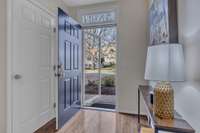 Entry on lower level at garage. The door to the left is the powder room. Hardwood flooring at entry. New heavy-duty storm door.