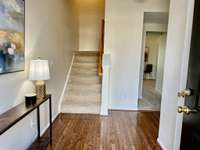 Entry foyer with hardwood and looking through to the bonus room at the back. Nice closet under the stairs. Door to garage around the corner and powder room right behind the front door.