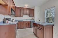 Lovely L-shaped work space with an island. Pantry in the corner. Pull outs in cabinets.