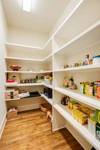 Who wouldn't love this walk-in pantry with wood shelving?