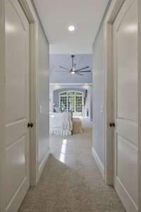 Hallway with his and hers closets lead back to master bath.