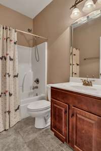 Full bathroom located by the two bedrooms in the back of the home (opposite the primary)