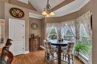 Breakfast nook in bay window overlooking private backyard