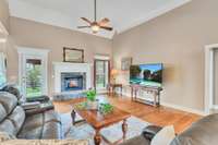 Great room with vaulted ceiling, ceiling fan, fireplace and sand and finish hardwood floors!