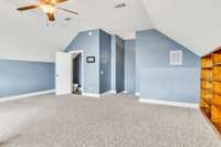 Another view of the bonus room with the guest half bath located over the garage