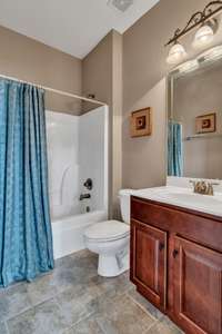 Full bathroom located around the corner from the front bedroom/office,