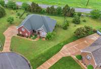 Aerial view . . . home located on cul-de-sac with aggregate driveway, 2 car side entry garage and extra driveway turnaround room