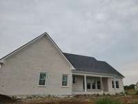 Back of house has covered patio