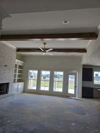 Fireplace with book shelves to each side, big windows for natural light