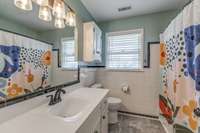 Bathroom with upgraded fixtures and new flooring.