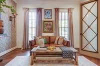 Through a set of strikng antique doors is a lovely living room