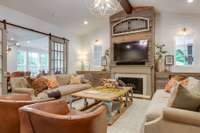 An open and inviting living room - gas fireplace with custom cabinetry on either side