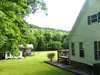 Side view of home. Lush and green