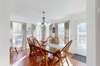 Sunlit dining area with  French door leading to outside deck for morning coffee