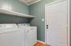 Conveniently located off the kitchen, the laundry room includes a washer and dryer that convey with the home.