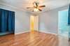 The primary bedroom also showcases wood floors.