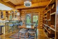 The dining room is adjacent to the kitchen bar and back door into the patio area