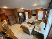 Den or living room downstairs with built-in's and large storage closet.  A nice place for friends or family to relax