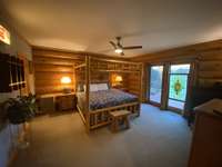 The primary suite with double door out to the front deck and sauna