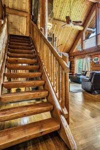 Spectacular half split logs make up the stairs going to the loft