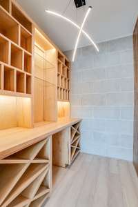 Custom wine room with wooden slat wall and limestone wall.