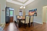 Separate dining room is large and has two decorative doors and a trey ceiling.