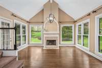 The sun-filled primary-level den is the perfect corner of your home for cozy relaxation even on the rainiest day. Massive paneless windows provide direct views to your breathtaking backyard while stunning high-mantled fireplace adds character.