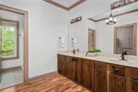 The natural-toned bathroom complete with dual vanity and separate water closet and shower allow for multiple use of the space at any given time. Convenience for the whole family!