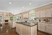 The well-appointed kitchen is a home chef's dream! Ample cabinet space, a dazzling central island complete with gas range, and sleek countertops invite you to cook your favorite nostalgic meal or to try that new recipe you've been considering.