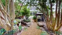 Tastefully designed courtyard with waterfall, creek bed, koi pond, patio area and irrigation system