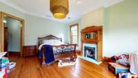 3rd bedroom has ornate fireplace, hardwood floors, individual climate controlled