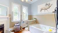 Primary bath with soaking tub, separate shower and a fireplace