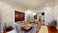 Formal dining room is large and spacious and the perfect place for entertaining.  Hand carved woodwork and pocket doors.