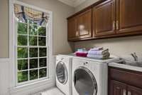 The Laundry Room off the kitchen features a Dutch door, allowing easy access while letting in natural light and maintaining privacy.