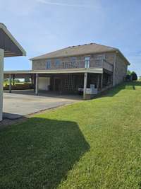 Anothe view of the carport, deck off of dining area and garage access.