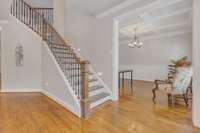 Foyer with beautiful wood banisters and iron railing