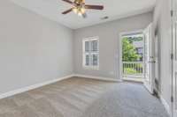 2nd bedroom with walk in closest, porch access, ceiling fan and private bathroom