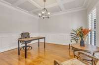 Office features wainscoting, coffered ceiling treatment and view out front