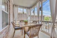 The screened porch overlooks the beautiful patio area an is just outside the main living room.